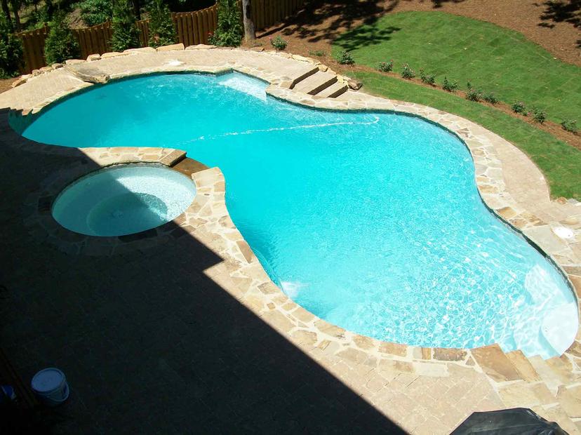 Overhead view of figure-eight pool with round spa and flagstone coping